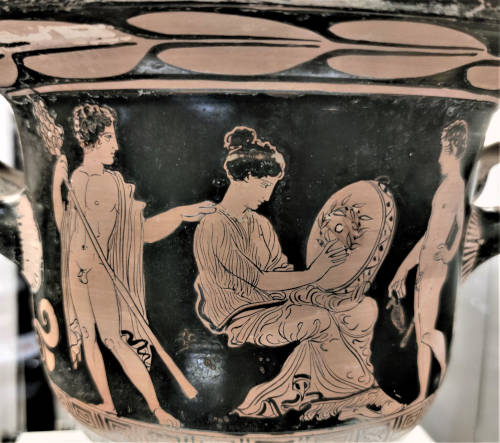 Vaso nero con decorazione di donna seduta che osserva un tamburello tra due uomini